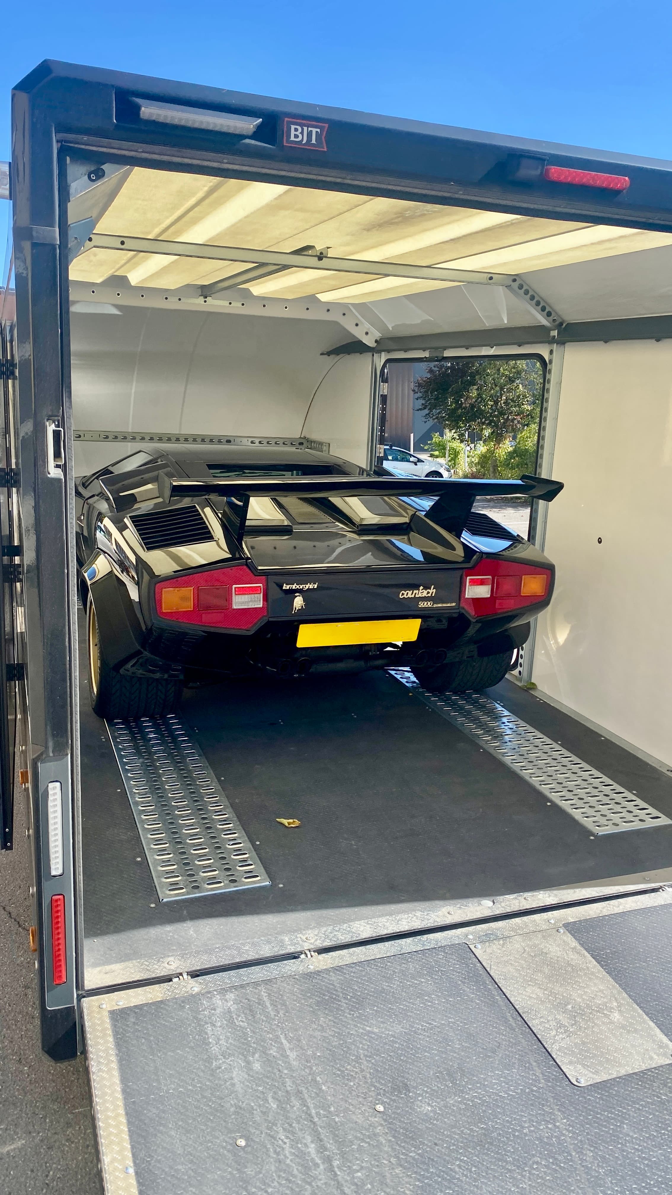 Lamborghini Countach noire chargée dans remorque Brian James RT7